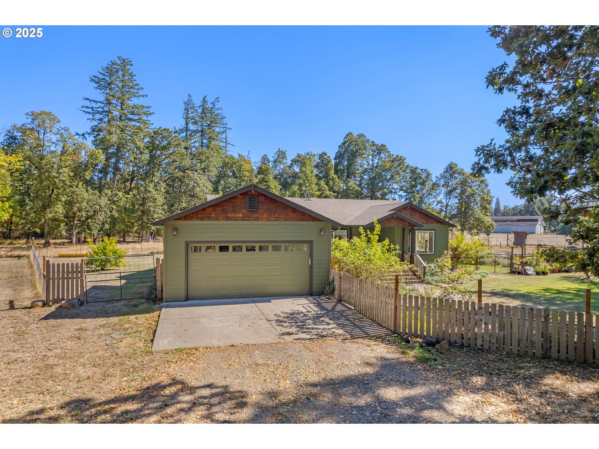 78691 Sears Road Cottage Grove, OR 97424 - Photo 36 of 48 a view of a brick house with a small yard and a large tree