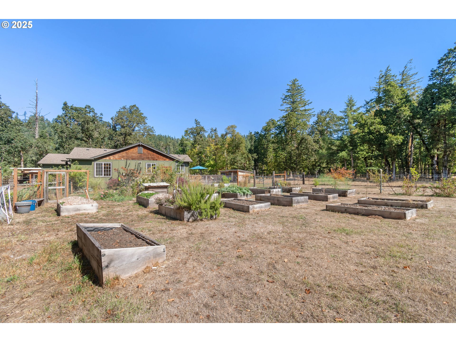78691 Sears Road Cottage Grove, OR 97424 - Photo 38 of 48 a view of a terrace with chairs and wooden fence