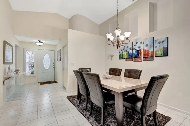 a living room with furniture a ceiling fan and a rug
