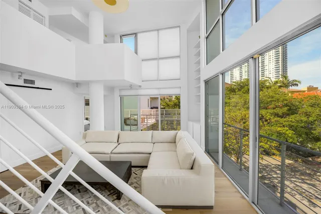 a living room with furniture a large window with outer view