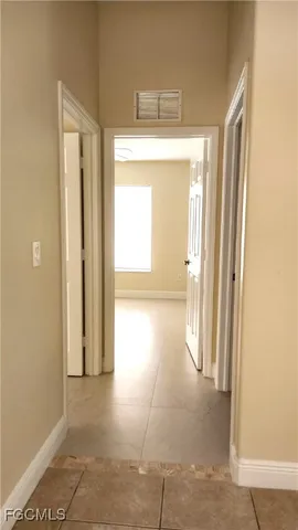 a view of a room with an empty space and a window