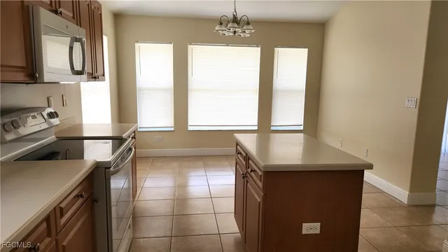 a kitchen with a sink a counter top space cabinets and a window