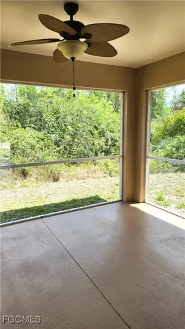 a view of an empty room and a window