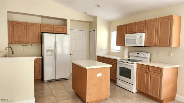 a kitchen with stainless steel appliances granite countertop a stove a refrigerator and a sink