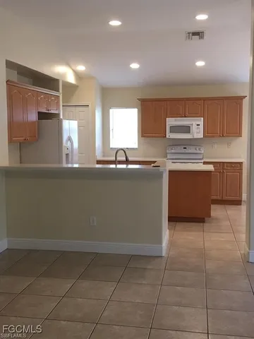 a kitchen with stainless steel appliances granite countertop a sink and a stove