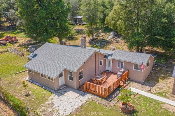 an aerial view of a house with a yard