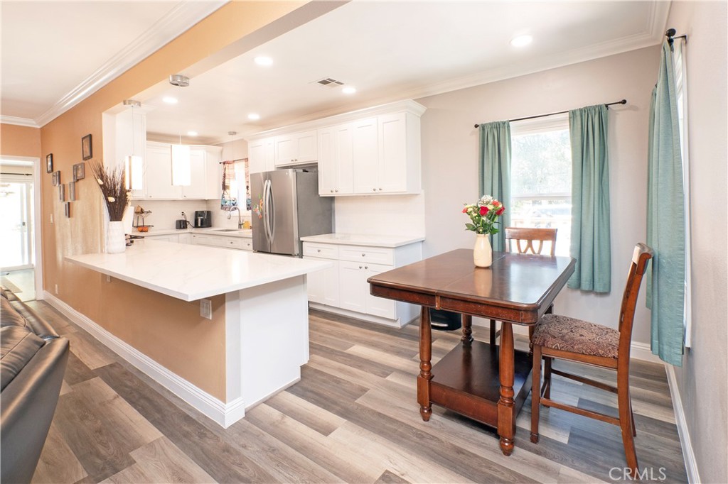18839 Deer Trail Road Banning, CA 92220 - Photo 18 of 47 a kitchen with stainless steel appliances kitchen island granite countertop a table chairs and a refrigerator