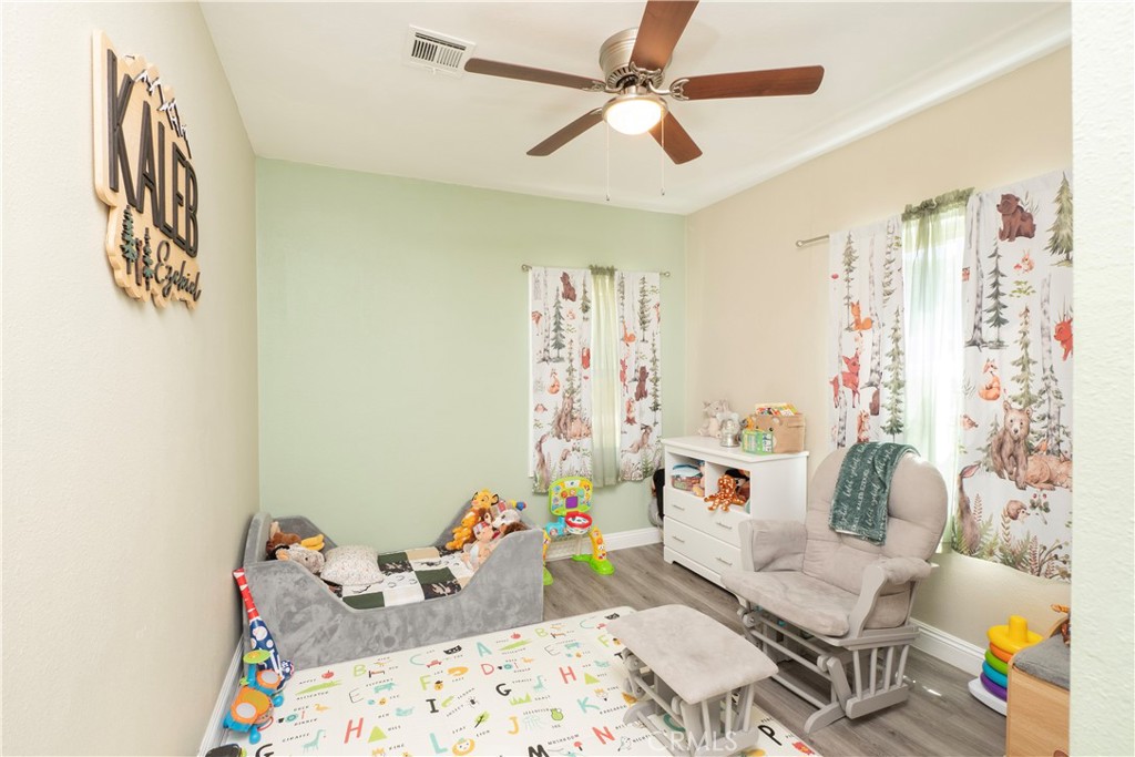 18839 Deer Trail Road Banning, CA 92220 - Photo 22 of 47 a bedroom with furniture and a chandelier