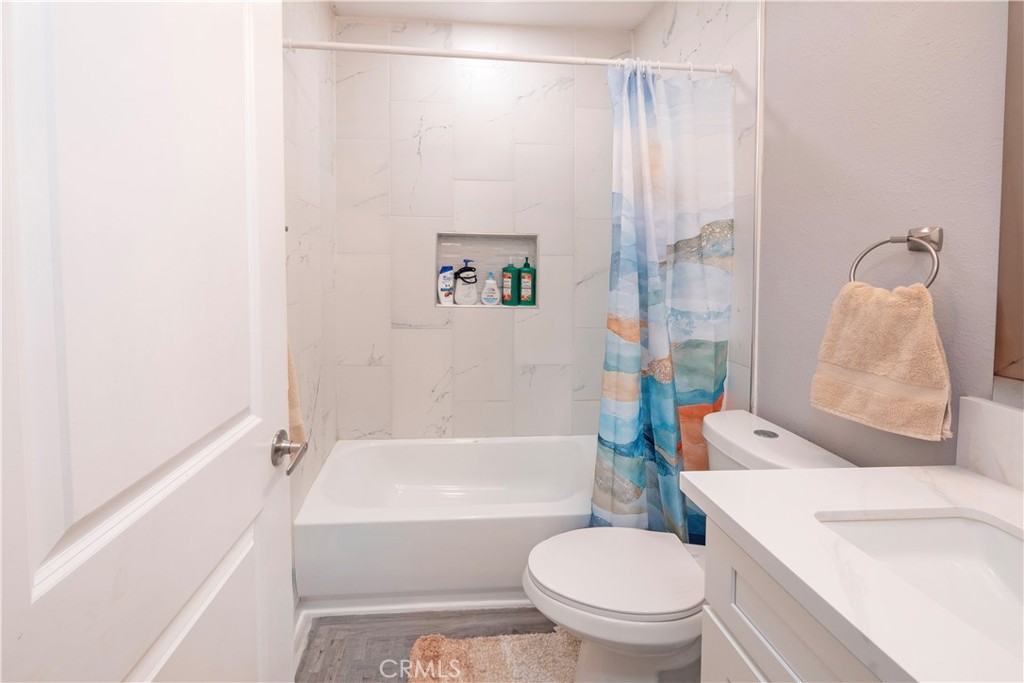 18839 Deer Trail Road Banning, CA 92220 - Photo 25 of 47 a bathroom with a toilet and a shower curtain