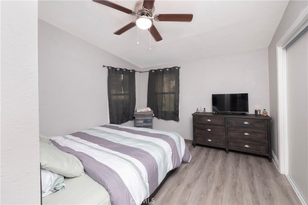 18839 Deer Trail Road Banning, CA 92220 - Photo 27 of 47 a bedroom with a bed and a flat tv screen on dresser