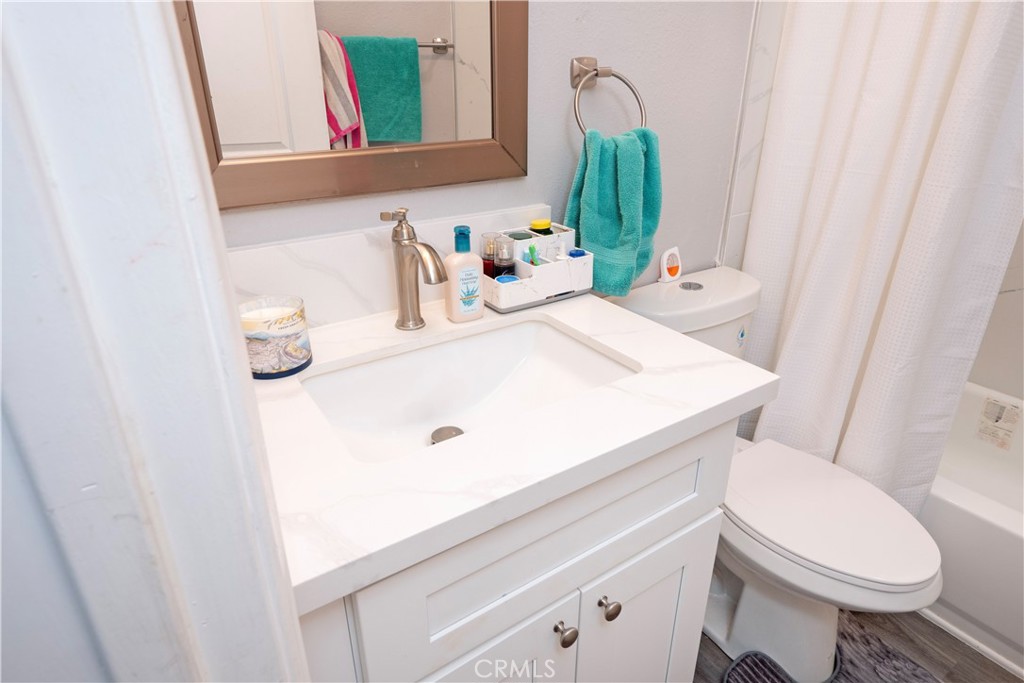 18839 Deer Trail Road Banning, CA 92220 - Photo 32 of 47 a bathroom with a sink a toilet and mirror