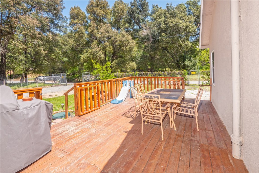 18839 Deer Trail Road Banning, CA 92220 - Photo 10 of 47 a view of a chairs and table on the wooden deck