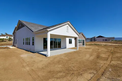 a view of house with yard and garage