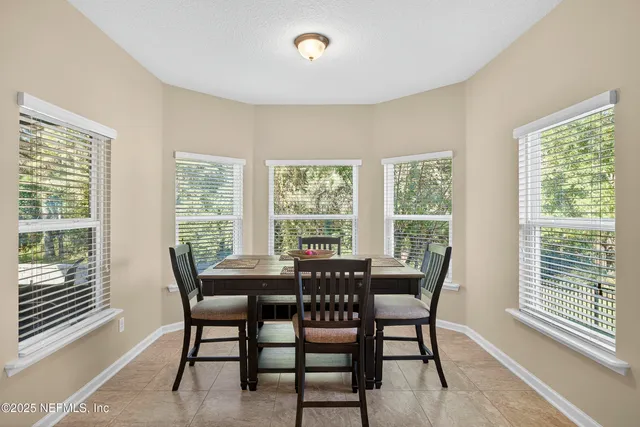 a dining room with furniture and window