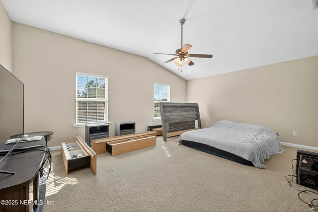 a bedroom with a bed and a television