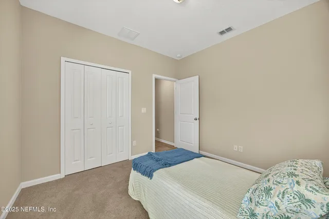 a bathroom with a toilet sink vanity and mirror