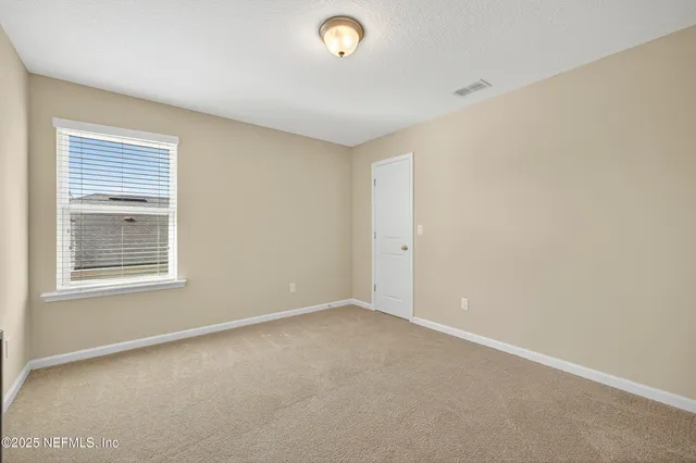 a bathroom with a double vanity sink toilet and a mirror