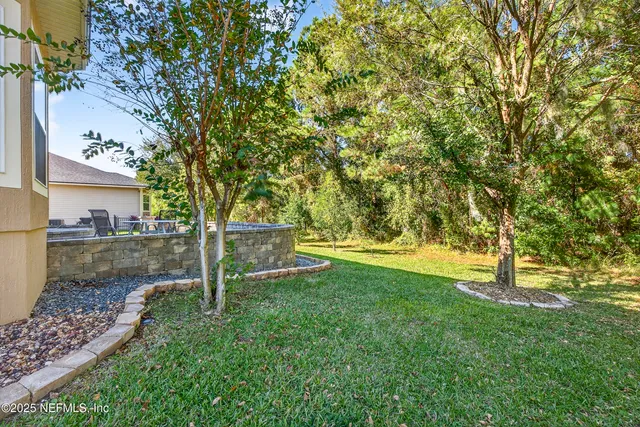 an aerial view of a house with a yard and swimming pool