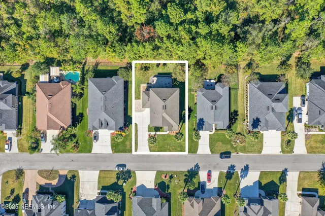 an aerial view of a house with a swimming pool yard and outdoor seating