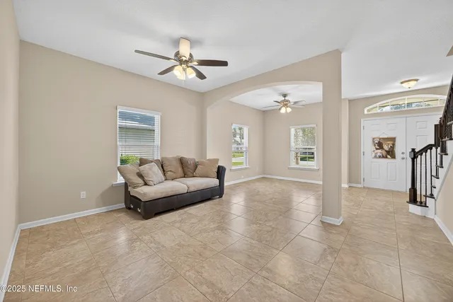 a living room with furniture and a chandelier
