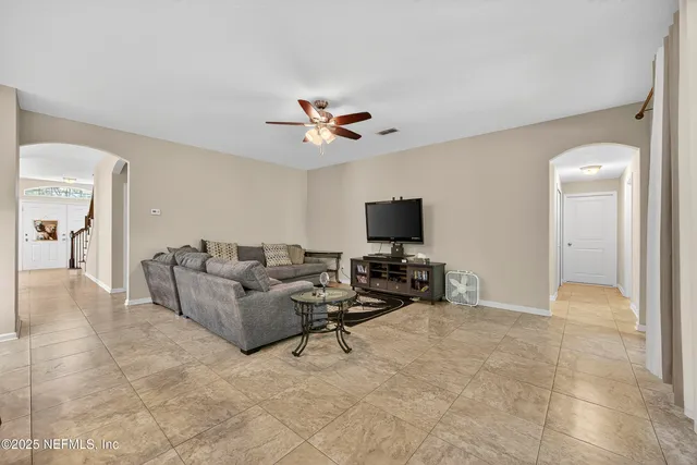 a living room with furniture and a flat screen tv