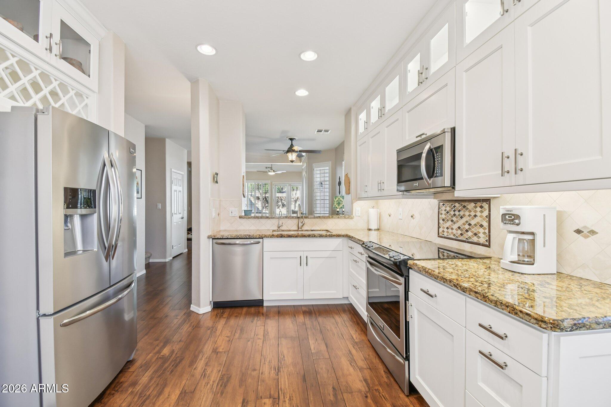 1024 East Frye Road, Unit 1039 Phoenix, AZ 85048 - Photo 8 of 32 a kitchen with granite countertop stainless steel appliances a sink a counter top space cabinets and stainless steel appliances