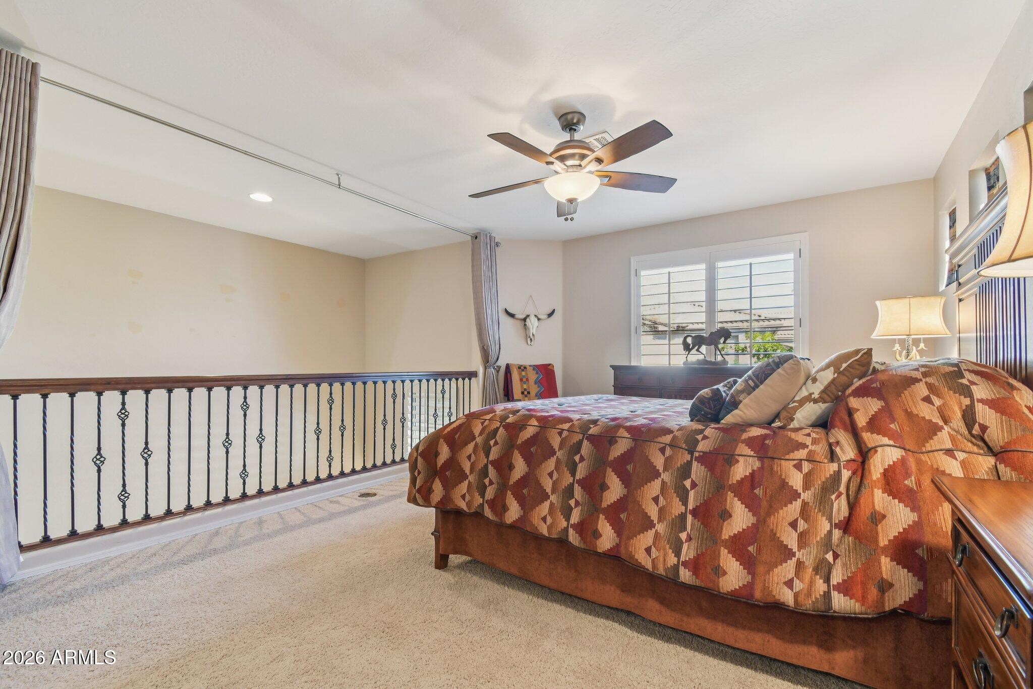 1024 East Frye Road, Unit 1039 Phoenix, AZ 85048 - Photo 17 of 32 a bed room with a bed and a chandelier