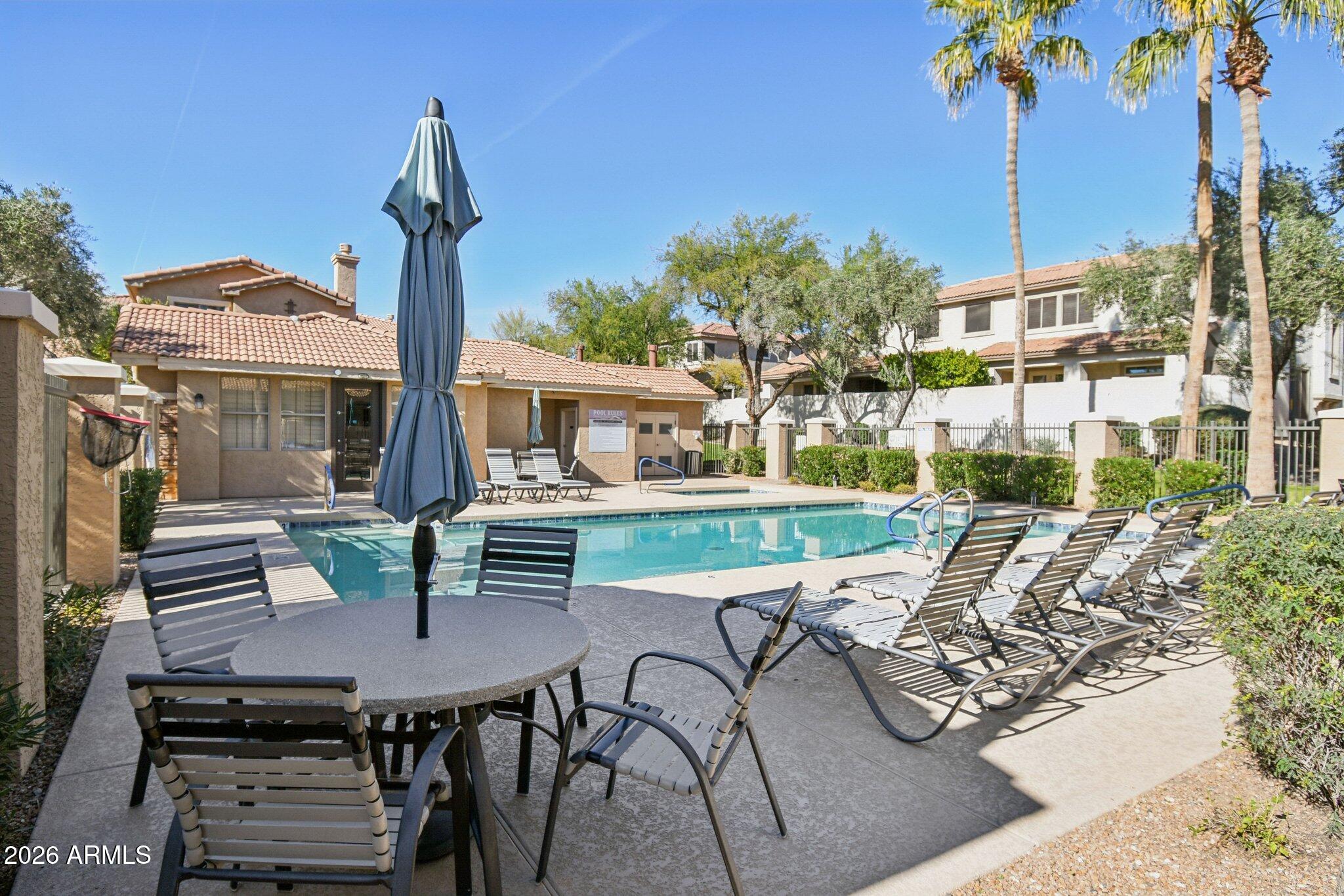 1024 East Frye Road, Unit 1039 Phoenix, AZ 85048 - Photo 29 of 32 a view of a patio with table and chairs potted plants with wooden floor and fence