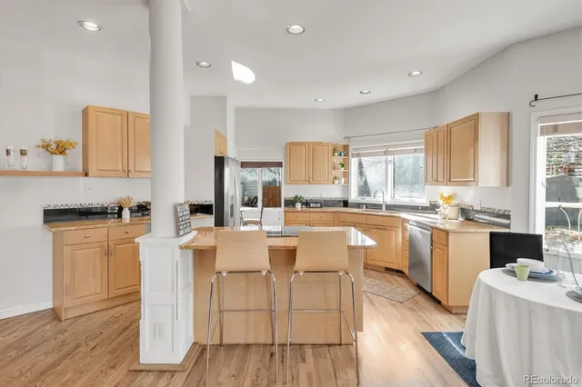 a kitchen with stainless steel appliances a stove a refrigerator sink and cabinets