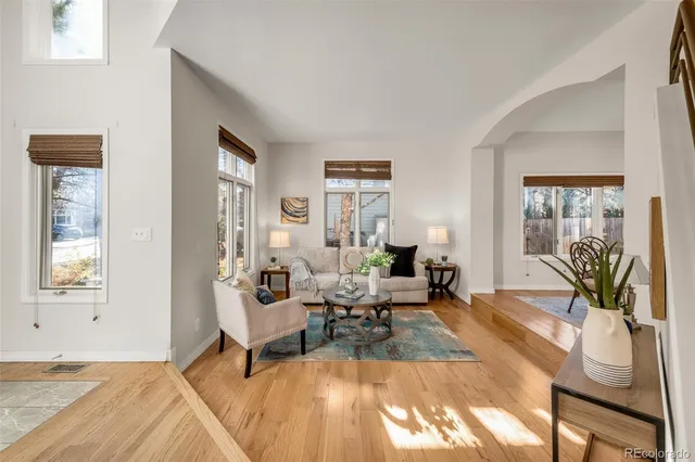 a dining room with furniture a chandelier and wooden floor