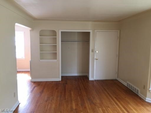 3597 Normandy Road Cleveland, OH 44120 - Photo 15 of 26 Unfurnished bedroom with a closet and dark hardwood / wood-style flooring