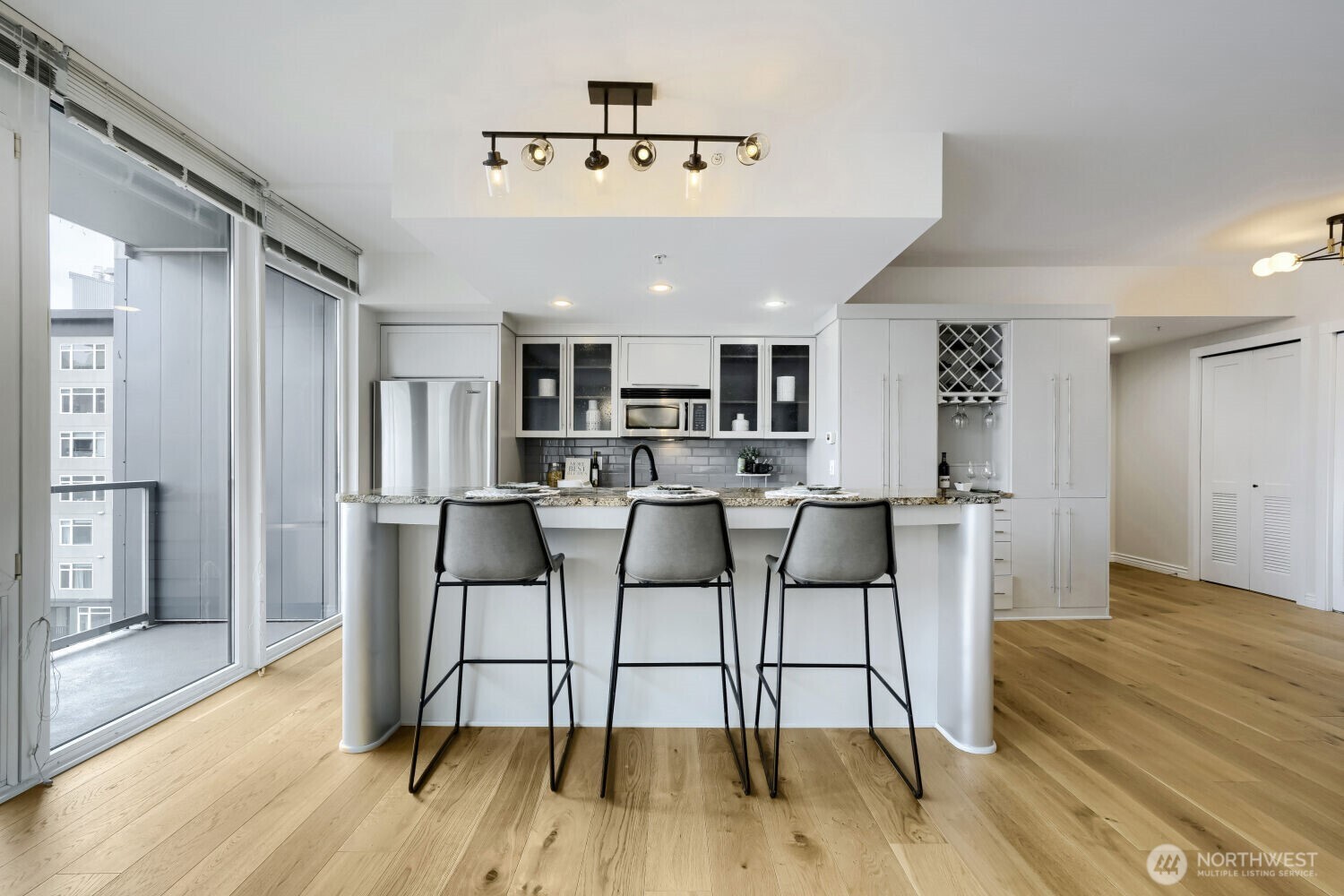 76 Cedar Street, Unit 1109 Seattle, WA 98121 - Photo 13 of 28 a view of a dining room with furniture and wooden floor