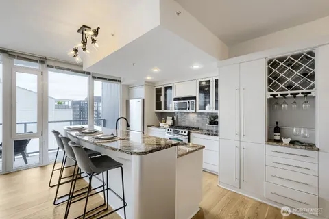 a kitchen with a table chairs refrigerator and microwave