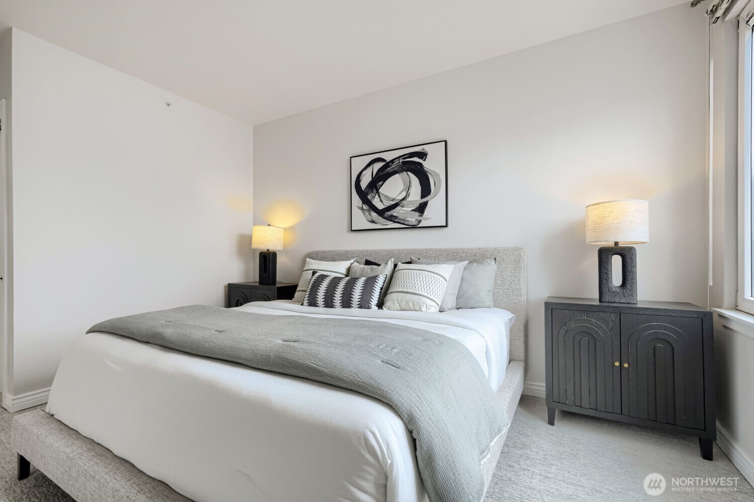 76 Cedar Street, Unit 1109 Seattle, WA 98121 - Photo 17 of 28 a bedroom with a bed and a lamp on dresser