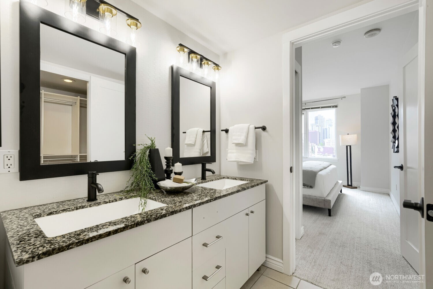 76 Cedar Street, Unit 1109 Seattle, WA 98121 - Photo 20 of 28 a en suite bathroom with double sink and a mirror