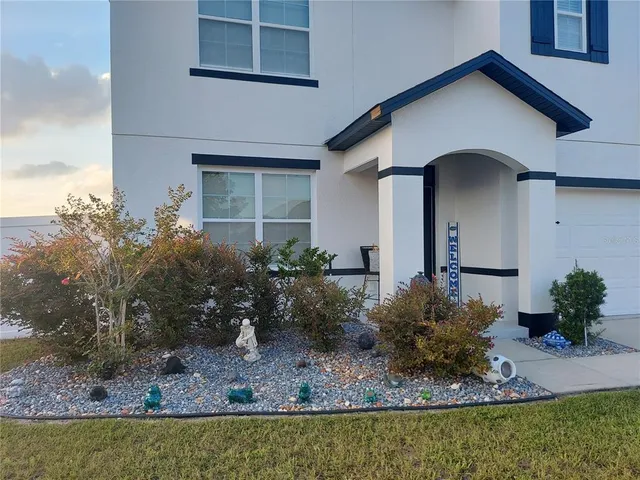 a front view of a house with garden