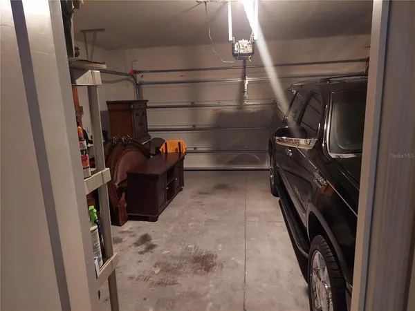 a view of a hallway with wooden floor and closet