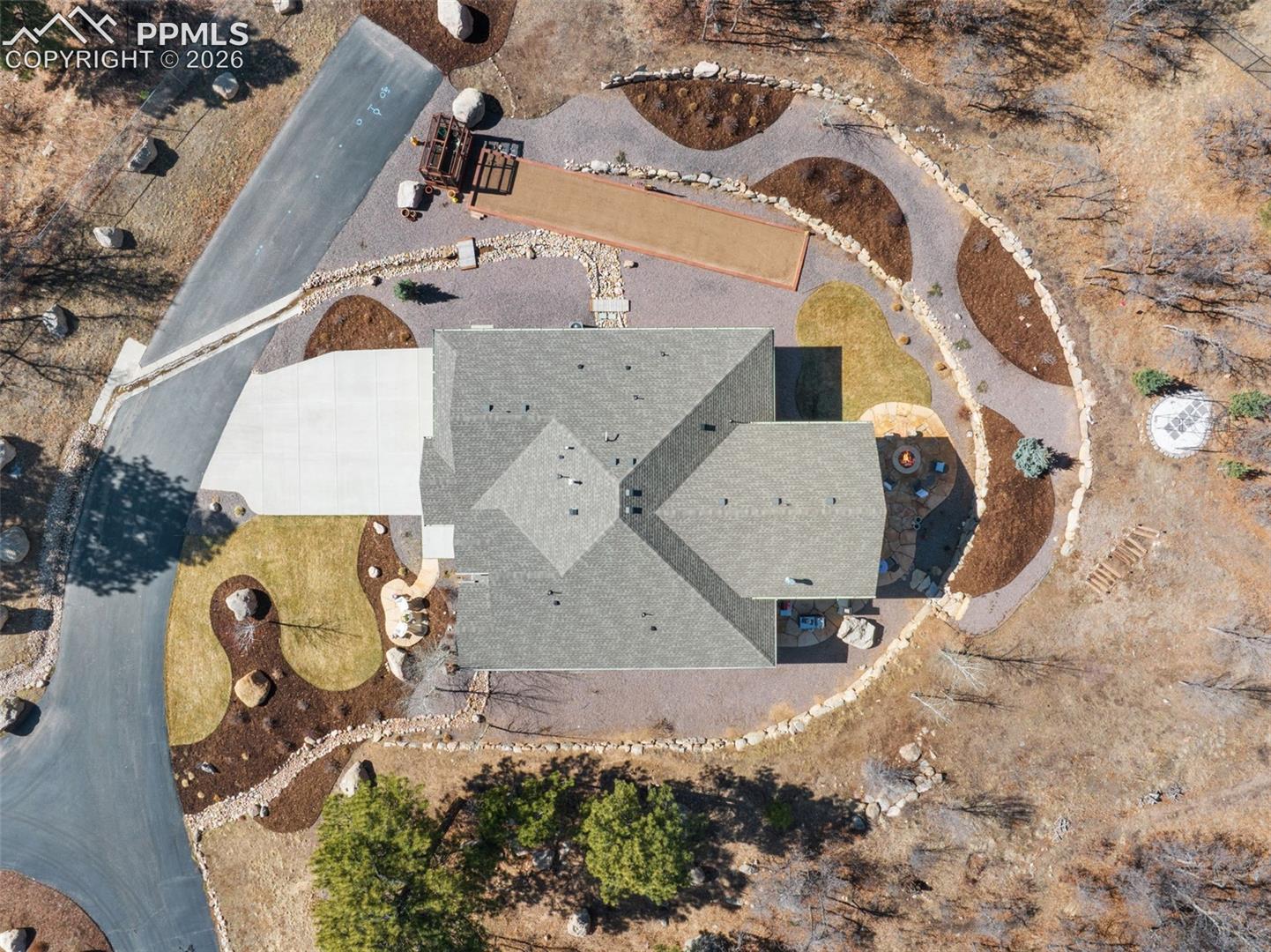 5318 Rocking Tree Grove Colorado Springs, CO 80906 - Photo 46 of 49 This top-down aerial perspective reveals the meticulous geometry of the lot, showcasing how the home, bocce court, patios, and gardens are intelligently zoned to maximize the usable footprint of the lot