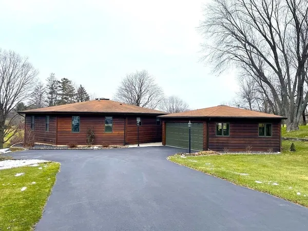 a kitchen with kitchen island granite countertop a table chairs stove and refrigerator