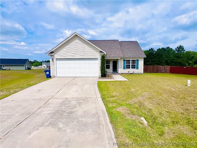 a view of a house with pool and yard
