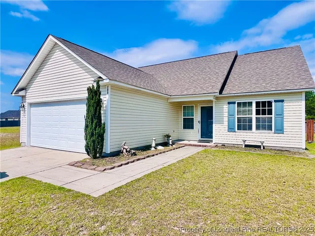 a view of a house with pool and sitting area