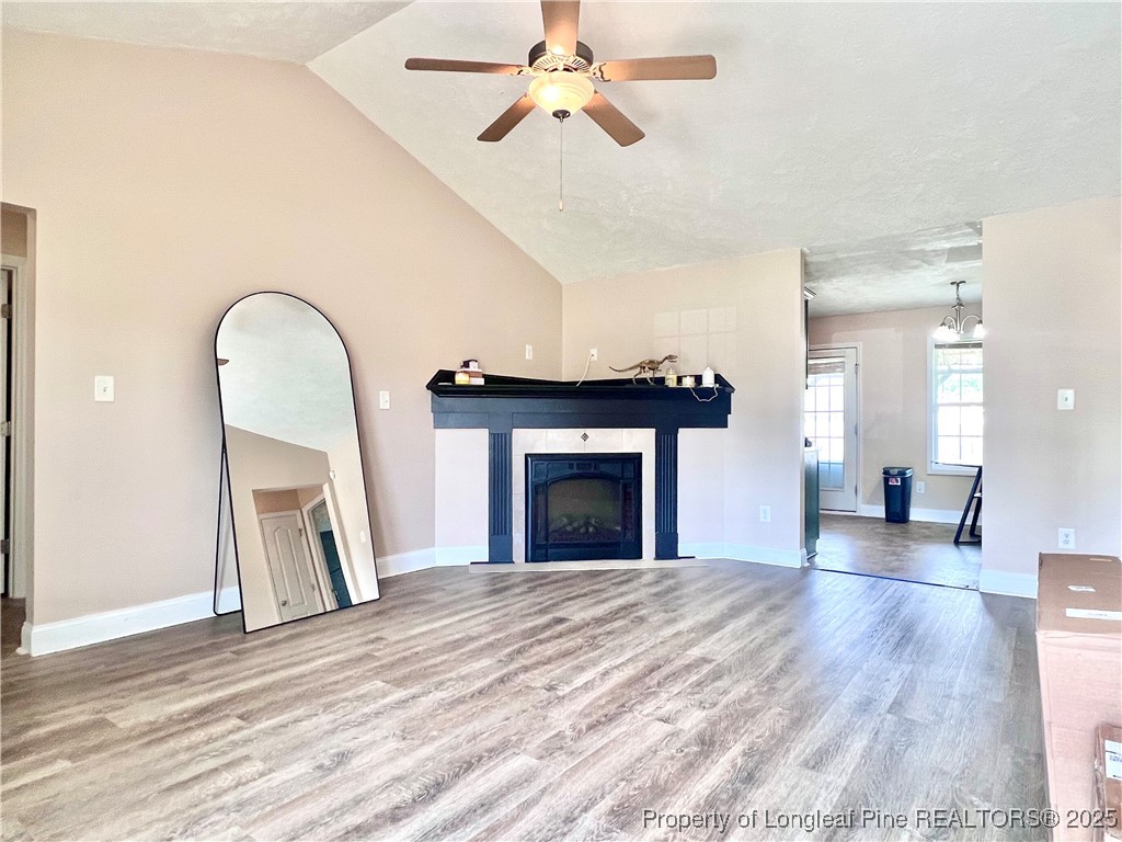 285 Pebble Lane Raeford, NC 28376 - Photo 3 of 7 a view of a livingroom with a fireplace a chandelier and wooden floor