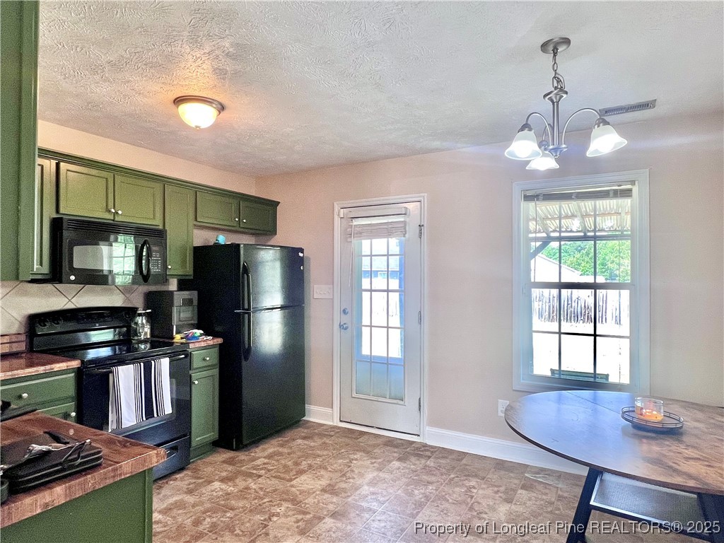 285 Pebble Lane Raeford, NC 28376 - Photo 6 of 7 a kitchen with stainless steel appliances granite countertop a refrigerator a sink dishwasher a stove and a refrigerator