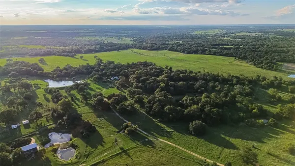 an aerial view of a houses with a yard