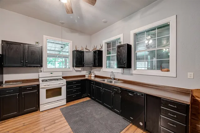 a kitchen with stainless steel appliances granite countertop a stove and a sink