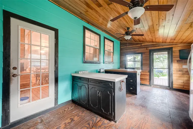 a view of a kitchen with a sink and dishwasher with wooden floor