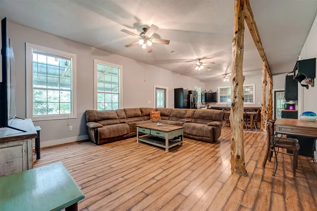a living room with furniture and a chandelier