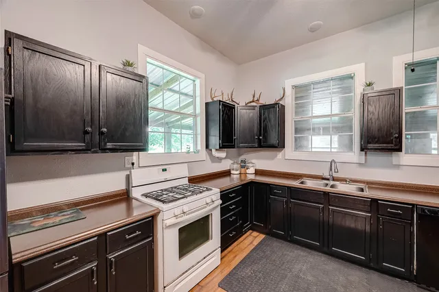 a kitchen with a sink stove and microwave