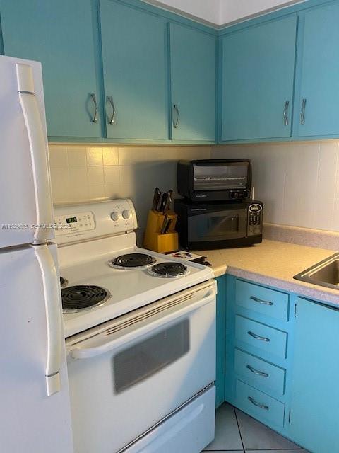 1000 Southwest 11th Avenue, Unit 20E Hallandale Beach, FL 33009 - Photo 4 of 12 a kitchen with a stove and a cabinets
