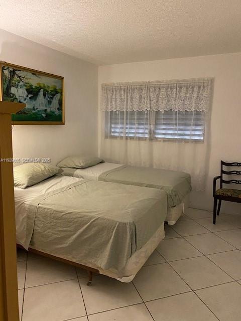 1000 Southwest 11th Avenue, Unit 20E Hallandale Beach, FL 33009 - Photo 6 of 12 a bedroom with a bed and a window